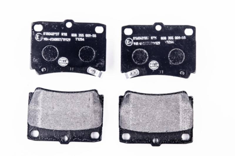 HELLA Bremsbeläge hinten - mit akustischer Verschleißwarnung - vier Bremsbeläge pro Set - T1254 - für u.a. MITSUBISHI - 8DB 355 009-501 von Hella